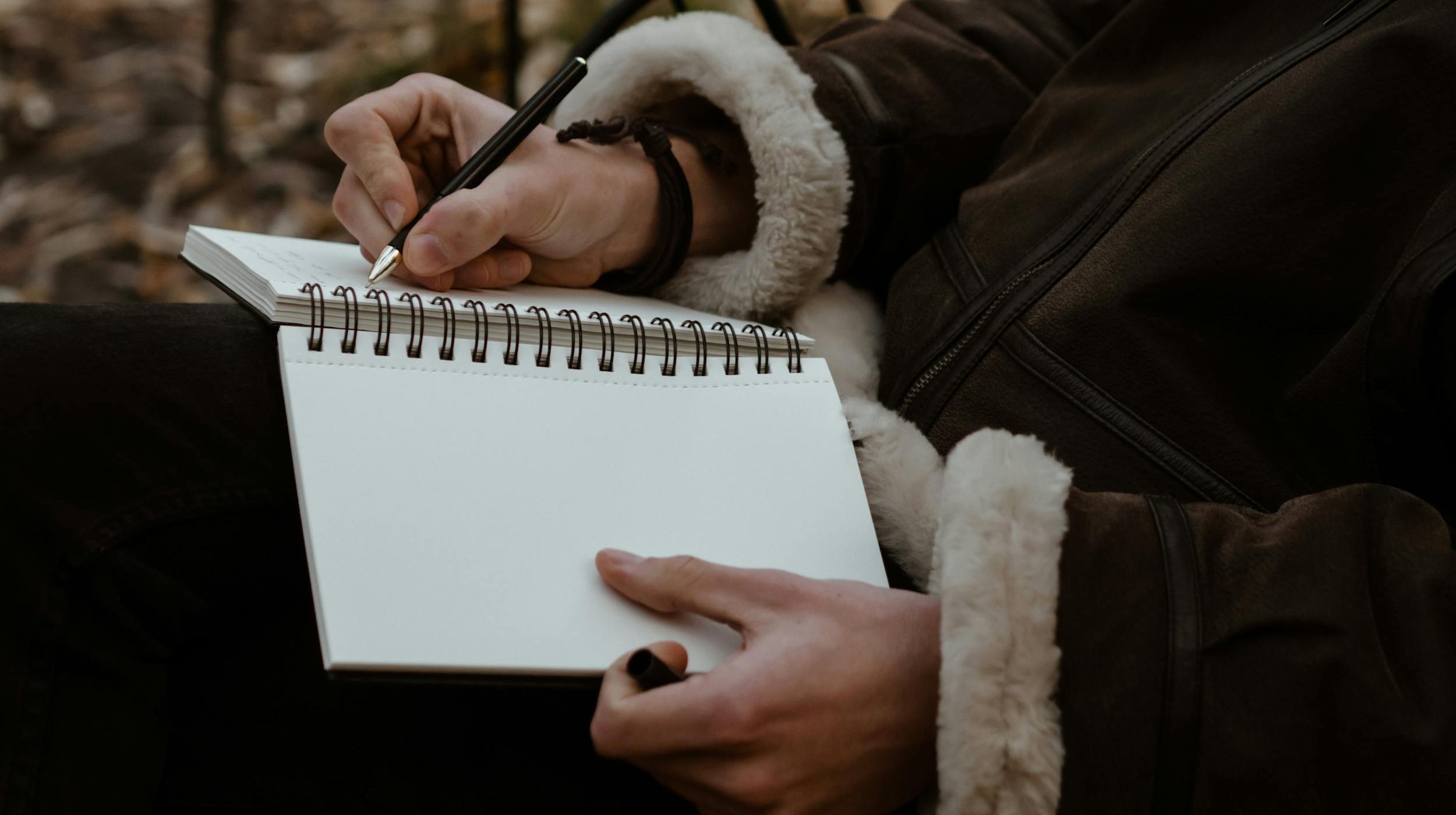 Man writing something in diary